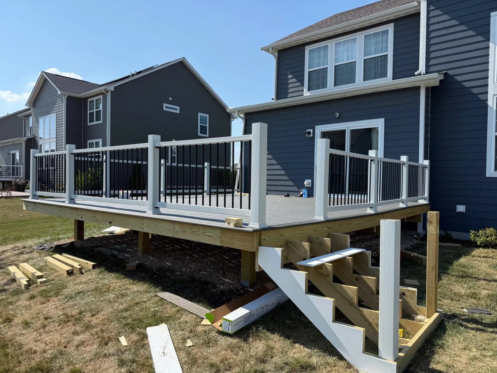 Elevated composite deck with white railing and exposed support framing during construction in Naperville, IL